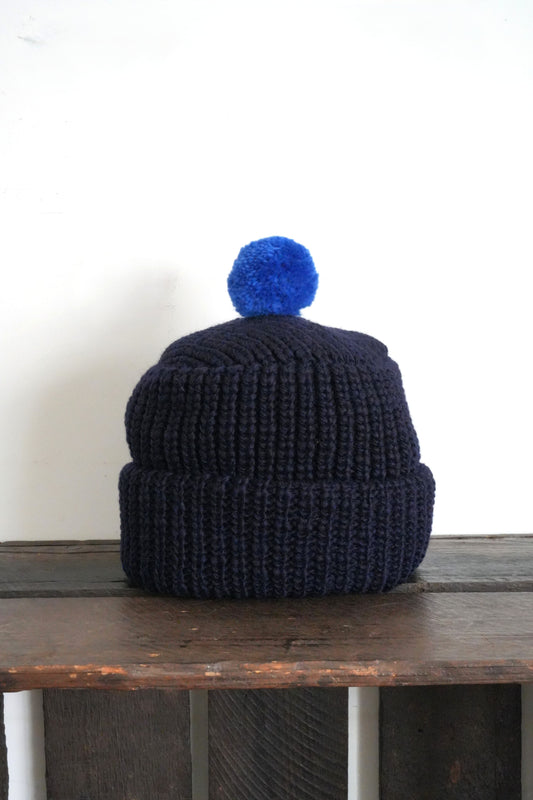「cableami」wool w/cap with POM -navy-
