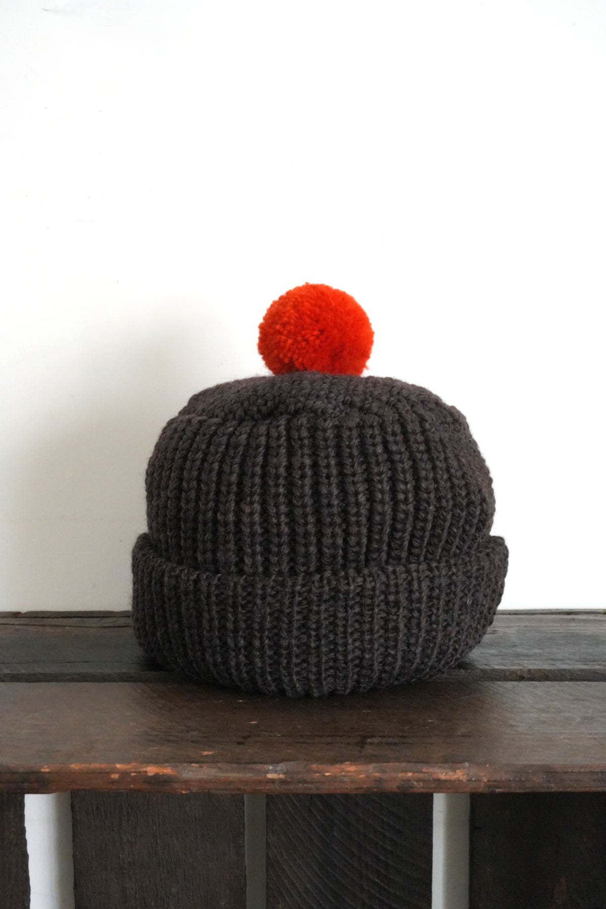 「cableami」wool w/cap with POM -brown-