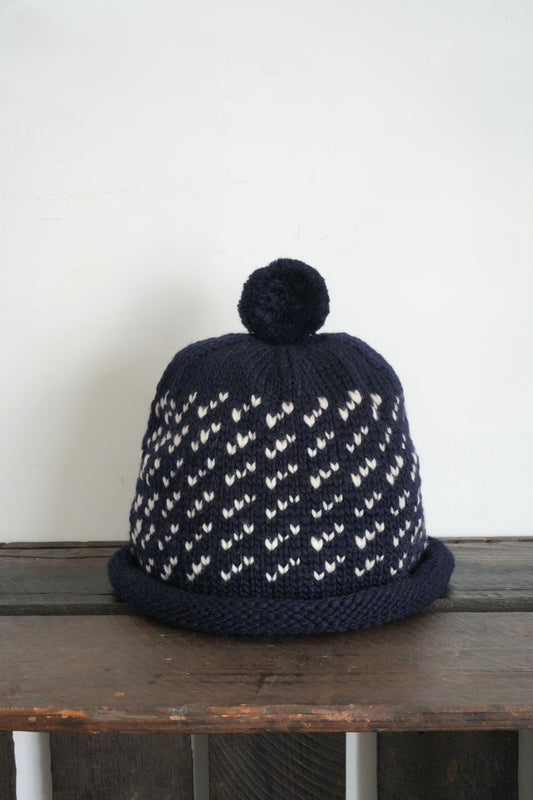 「cableami」wool jacquard w/cap with POM -navy-
